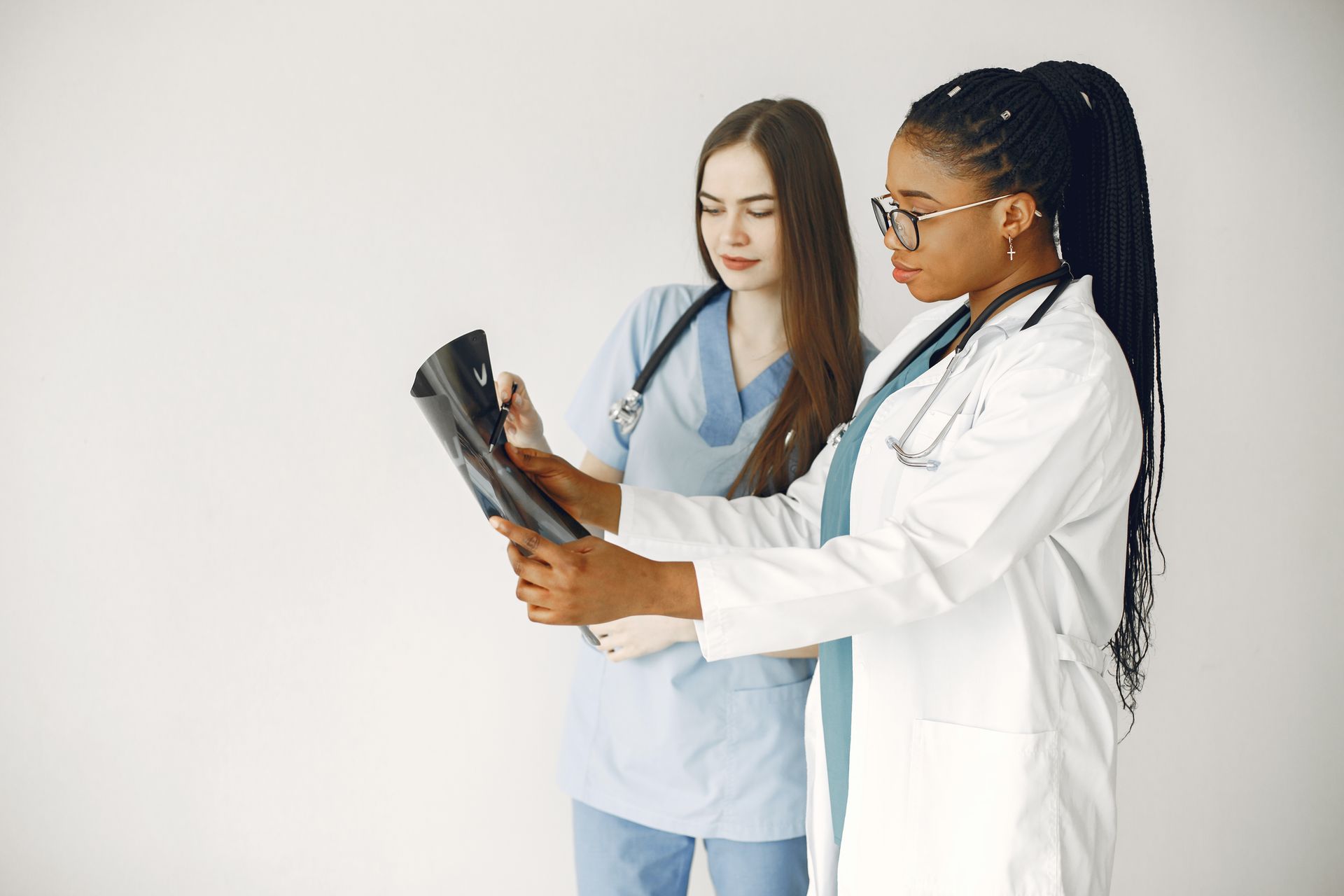 Two healthcare professionals reviewing an x-ray